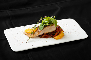 Close up of white fish fillet with vegetable stew