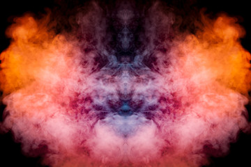 Obraz na płótnie Canvas A background of blue, red and orange wavy smoke in the shape of a ghost's head or a man of mystical appearance on a black isolated ground. Bright abstract pattern of steam from vape.
