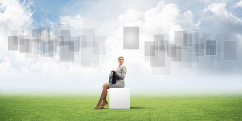 Attractive business lady or accountant outdoors on white box