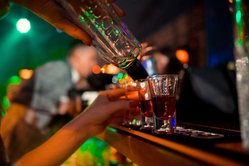  Bartender pours alcoholic cocktails.
