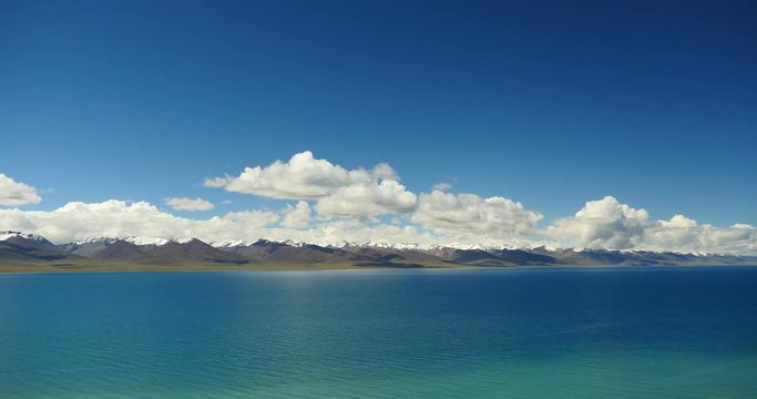 4k time lapse of huge clouds mass rolling over lake namtso & Tanggula snow mountain peak,tibet mansarovar,Tibet's second largest lake,is the third largest saltwater lake in China.