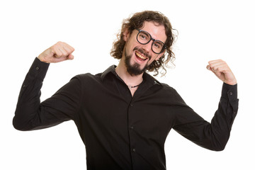 Happy handsome Caucasian man looking motivated with arms raised