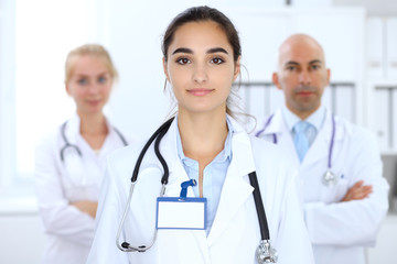 Fototapeta premium Happy doctor woman with medical staff at the hospital