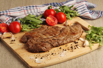 A beef steak well done with vegetables