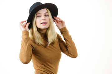Woman wearing suede and black hat