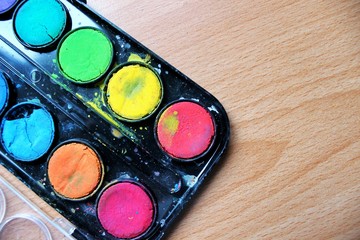 bright watercolor paint in box top view, with space for text