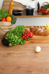 Desk  with many fresh vegetables and fruits in the kitchen. Cooking, vegetarian and shopping concept