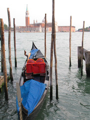 Fototapeta na wymiar Colorful gondolas in Venice, Italy frame the island of San Giorgio Maggiore