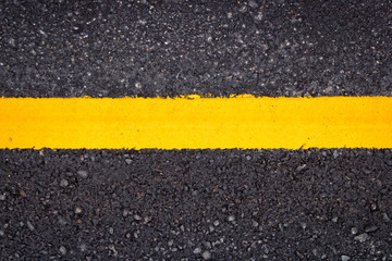 Asphalt road surface with yellow line