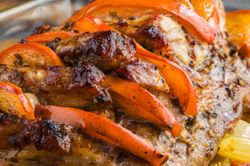 Spicy pork fillet baked with persimmon, apple, onion, carrot, bell pepper and celery, close-up
