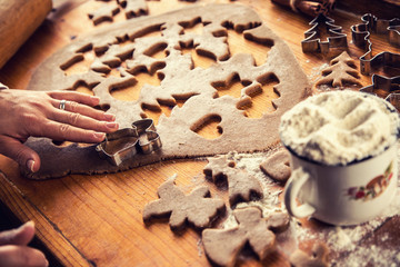 Gingerbread dough and woman hands preparing christmas biscuit cakes