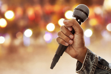 Hand holding microphone