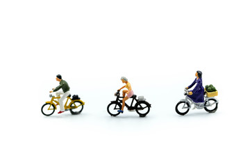 Fototapeta na wymiar Miniature people : man and friend ride bicycle on white background.