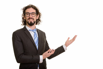 Happy handsome Caucasian businessman showing something while smiling