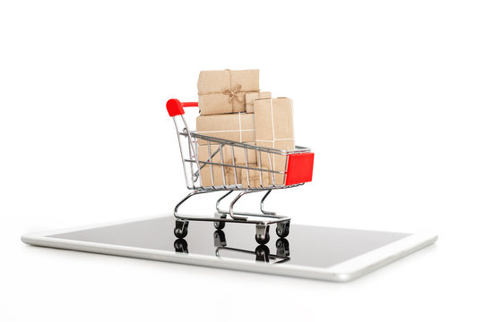 Online shopping and internet shopping delivery, Shopping cart full of boxes on digital tablet, isolated on white background