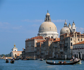 Fototapeta na wymiar Buildings and Waterfront Canals highlight the cityscape of Venice, Italy