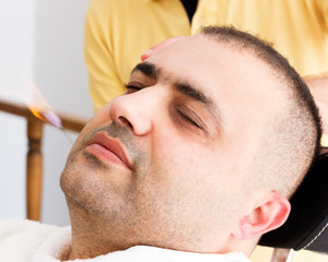 Fototapeta premium Turkish barber ear hair removal by burning fire