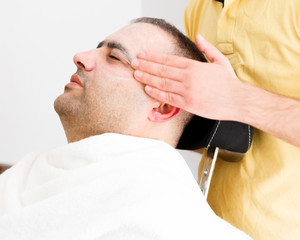 Obraz premium Facial massage for man in barber shop in Turkey
