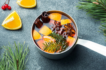 Christmas mulled wine with spices and fruit on the table. New year concept