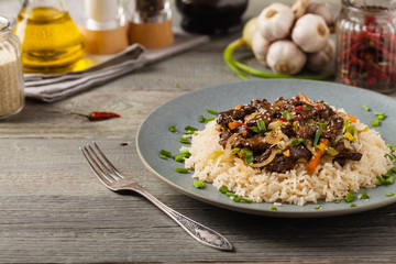 Traditional Korean Bulgogi dish.  Thinly cut, grilled beef, served with rice and vegetables.