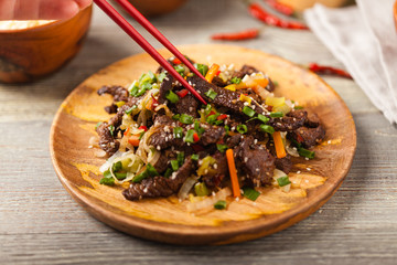 Traditional Korean Bulgogi dish.  Thinly cut, grilled beef, served with rice and vegetables.