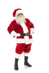 funny santa claus holds hips and leans back while standing