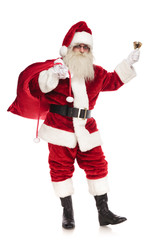 happy santa sings christmas carol while holding bag of presents