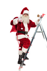 santa claus climbs the ladder while holding sack and bells