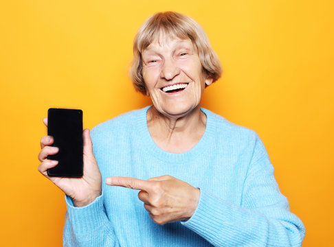 A picture of mature woman with new smartphone.