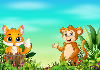 Obraz na płótnie Canvas Nature scene with a baby fox standing on tree stump and monkey