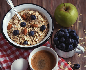 A healthy breakfast - Oatmeal porridge, boiled egg, milk, fresh berries and coffee. A great start to a new day. T