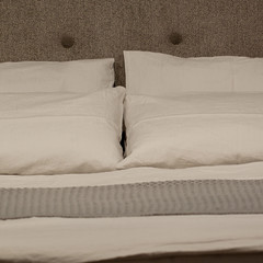 cozy bed with pillows for sleeping and rest