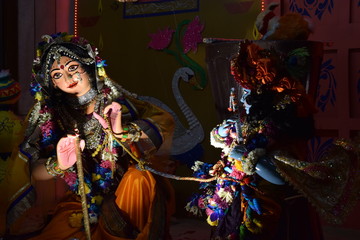 Image of colorful gods dancing in an ISKCON temple in Delhi, India