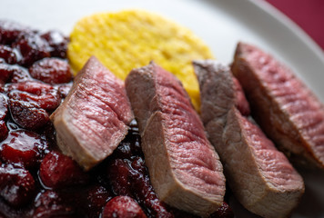 Beef steak with strawberries sauce