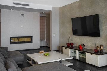 Interior of light spacious living room with fireplace in a luxury villa