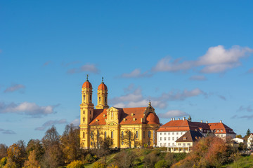 colors contrast with yellow church and blue sky in Ellwangen