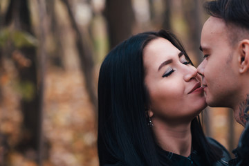 Fototapeta premium portrait of a young woman and a man walking in the autumn forest