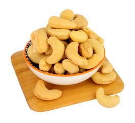 Bowl of roasted cashew nuts isolated on a white background