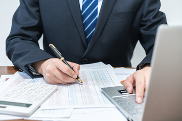 Businessmen using computer accounting