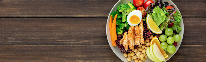 Clean food with mixed vegetable and fruit salad on wood banner background