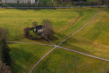 park with crossroads and green grass behind the castle