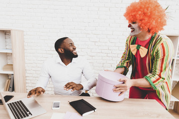 Young Man in Clown Costume on Meeting in Office.
