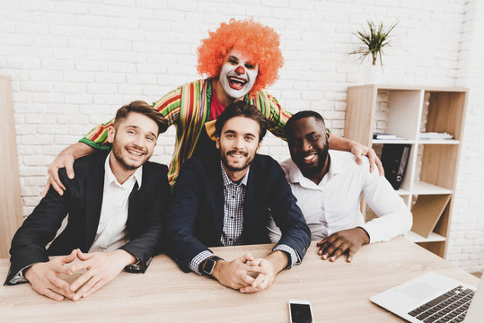 Young Man In Clown Costume On Meeting In Office.