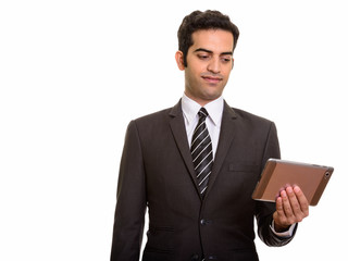 Portrait of young Persian businessman holding digital tablet