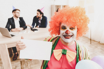 Young Man in Clown Costume on Meeting in Office.
