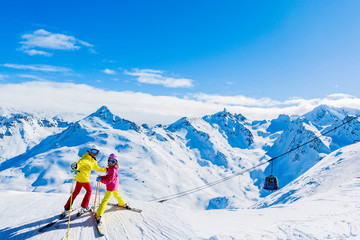 Happy family enjoying winter vacations in mountains, Val Thorens, 3 Valleys, France. Playing with...
