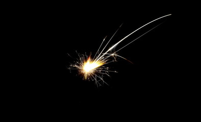 Ignited sparkler isolated on black background with clipping path