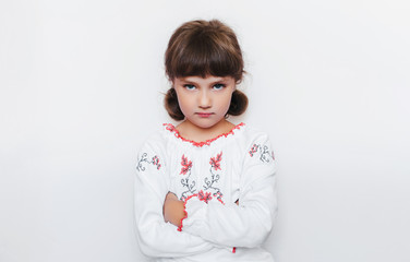 Strong independent Ukraine opposes the enemy. A small offended girl stands with arms crossed....