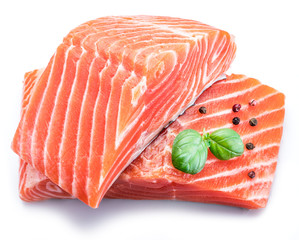 Fresh raw salmon fillets  decorated with green basil.