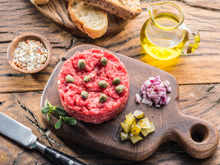 Steak tartare served with capers, pickled cucumbers and chopped onion.
